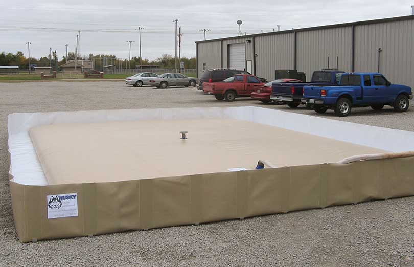 A husky bladder tank sitting inside a husky berm for extra spill protection