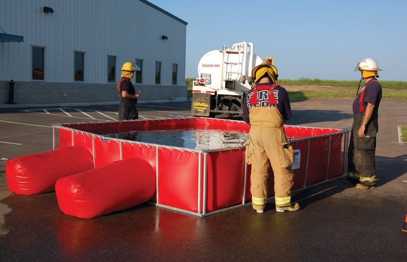 Firefighters using a PRO500 Folding Frame Tank