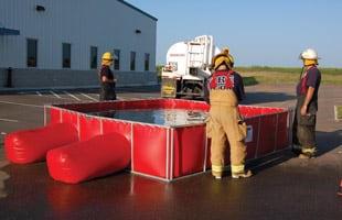 Firefighters using a PRO500 Folding Frame Tank