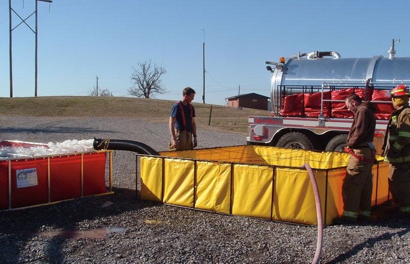 Folding Frame Tanks in use by firefighters on the scene to shuttle water