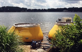Two Frameless Water Tanks at a Lake