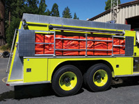 Firefighters use Husky's portable tank rack to mount a tank on their firetruck