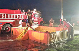 Firefighters emptying their tank using the Quick Dump